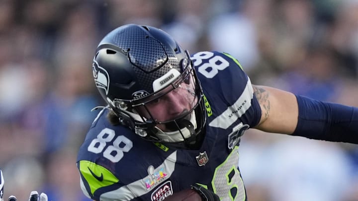 Seattle Seahawks tight end AJ Barner makes a catch against New England Patriots safety Craig Woodson.