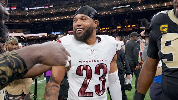 Dec 15, 2024; New Orleans, Louisiana, USA; New Orleans Saints linebacker Demario Davis (56) greets former teammate Washington Commanders cornerback Marshon Lattimore (23) next to New Orleans Saints defensive end Cameron Jordan (94) at the end of the game at Caesars Superdome. Mandatory Credit: Matthew Hinton-Imagn Images
