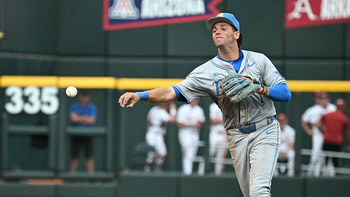 Jun 17, 2025; Omaha, Neb, USA;  UCLA Bruins shortstop Roch Cholowsky (1) completes a double play after getting Arkansas Razorbacks center fielder Justin Thomas Jr. (4) out during the fifth inning at Charles Schwab Field. Mandatory Credit: Steven Branscombe-Imagn Images
