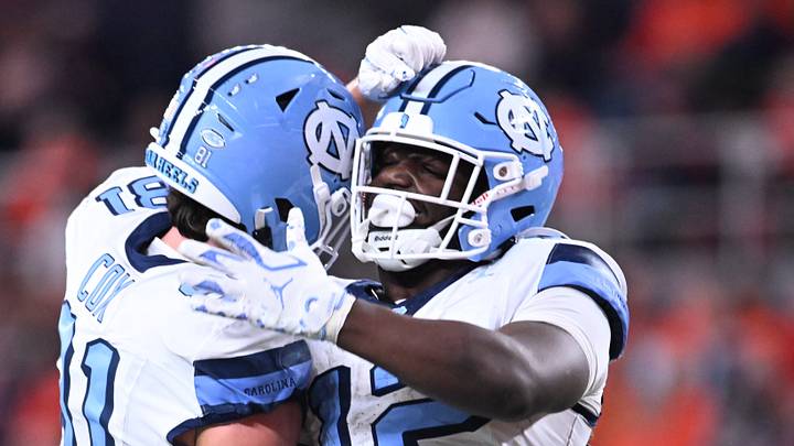 Oct 31, 2025; Syracuse, New York, USA; North Carolina Tar Heels running back Demon June (12) is greeted by tight end Conner Cox (81) after scoring a touchdown in the third quarter against the Syracuse Orange at the JMA Wireless Dome. Mandatory Credit: Mark Konezny-Imagn Images