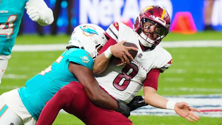 Former Miami Dolphins linebacker Bradley Chubb (2) tackles Washington Commanders quarterback Marcus Mariota (8) 