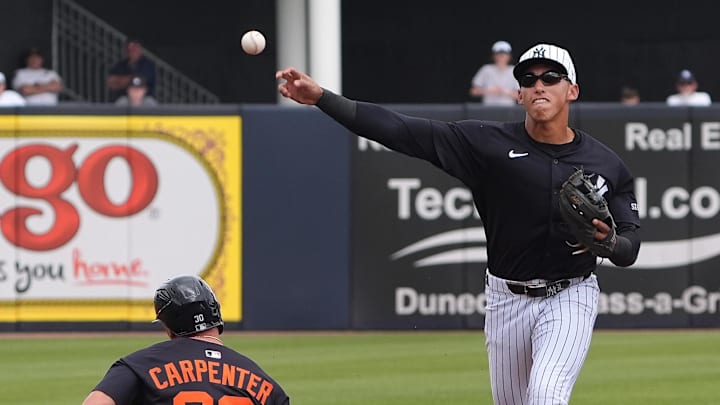Mar 10, 2025; Tampa, Florida, USA; New York Yankees shortstop George Lombard Jr. (96) throws to first to make the double play as Detroit Tigers outfielder Kerry Carpenter (30) slides into second during the first inning at George M. Steinbrenner Field.