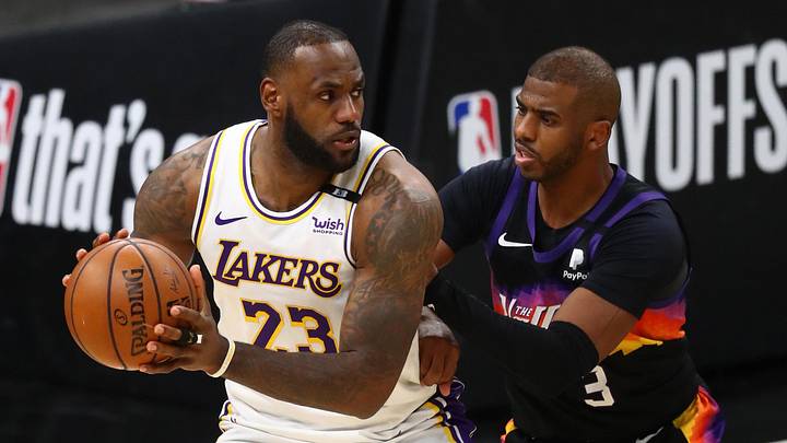 May 23, 2021; Phoenix, Arizona, USA; Los Angeles Lakers forward LeBron James (23) controls the ball against Phoenix Suns guard Chris Paul (3) during game one in the first round of the 2021 NBA Playoffs at Phoenix Suns Arena. Mandatory Credit: Mark J. Rebilas-Imagn Images