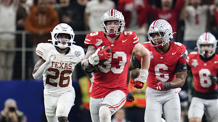 Ohio State Buckeyes defensive end Jack Sawyer (33) returns a fumble recovery for a touchdown after sacking Texas Longhorns quarterback Quinn Ewers (3) during the second half of the Cotton Bowl Classic College Football Playoff semifinal game at AT&T Stadium in Arlington, Texas on Jan. 10, 2025. Sawyer returned the fumble for a touchdown, and Ohio State won 28-14.