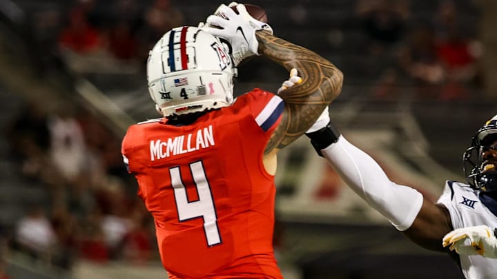 Oct 26, 2024; Tucson, Arizona, USA; Arizona Wildcats wide receiver Tetairoa McMillan (4) catches a long pass while West Virginia Mountaineers linebacker Trey Lathan (4) fails to defend against him during the fourth quarter at Arizona Stadium. Mandatory Credit: Aryanna Frank-Imagn Images