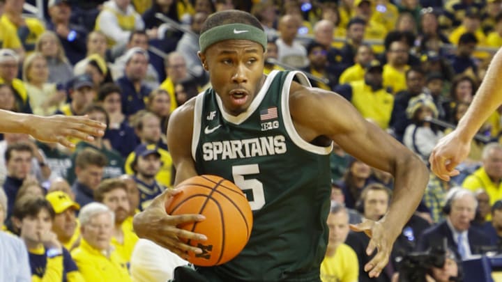 Feb 21, 2025; Ann Arbor, Michigan, USA; Michigan State Spartans guard Tre Holloman (5) handles the ball during the first half against the Michigan Wolverines at Crisler Center. Mandatory Credit: Brian Bradshaw Sevald-Imagn Images