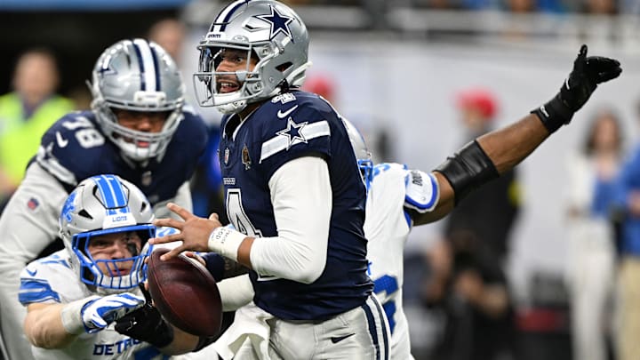 Dallas Cowboys quarterback Dak Prescott is pressured by Detroit Lions Al-Quadin Muhammad and Aidan Hutchinson.