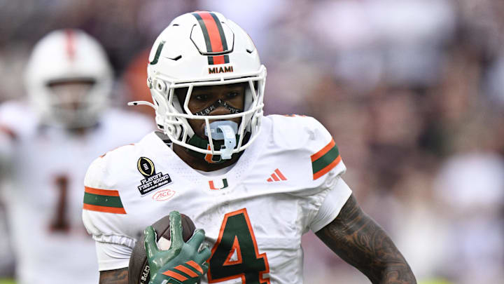 Dec 20, 2025; College Station, TX, USA; Miami Hurricanes running back Mark Fletcher Jr. (4) runs the ball against Texas A&M Aggies safety Dalton Brooks (25) during the second half of the first round game of the CFP National Playoff at Kyle Field. Mandatory Credit: Jerome Miron-Imagn Images