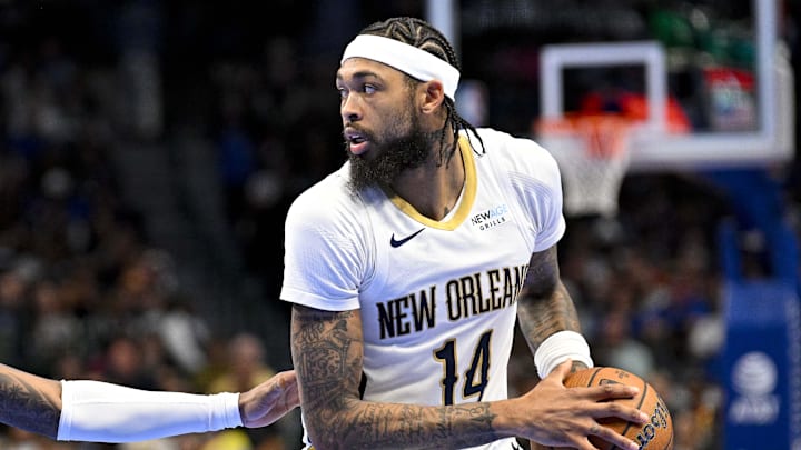 Nov 19, 2024; Dallas, Texas, USA; New Orleans Pelicans forward Brandon Ingram (14) looks to move the ball past Dallas Mavericks guard Jaden Hardy (1) during the first half at the American Airlines Center. Mandatory Credit: Jerome Miron-Imagn Images