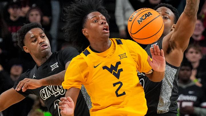 Feb 5, 2026; Cincinnati, Ohio, USA;  West Virginia Mountaineers guard Amir Jenkins (2) steals the ball away from Cincinnati Bearcats guard Jizzle James (2) and forward Jalen Celestine (32) in the second half at Fifth Third Arena. Mandatory Credit: Aaron Doster-Imagn Images