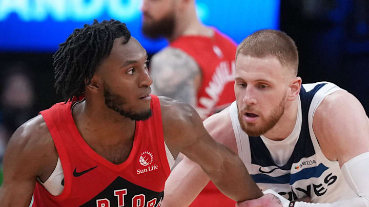 Toronto Raptors guard Immanuel Quickley dribbles against Minnesota Timberwolves guard Donte DiVincenzo.
