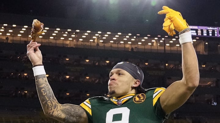Green Bay Packers receiver Christian Watson celebrates while holding a turkey leg after the win over Miami.
