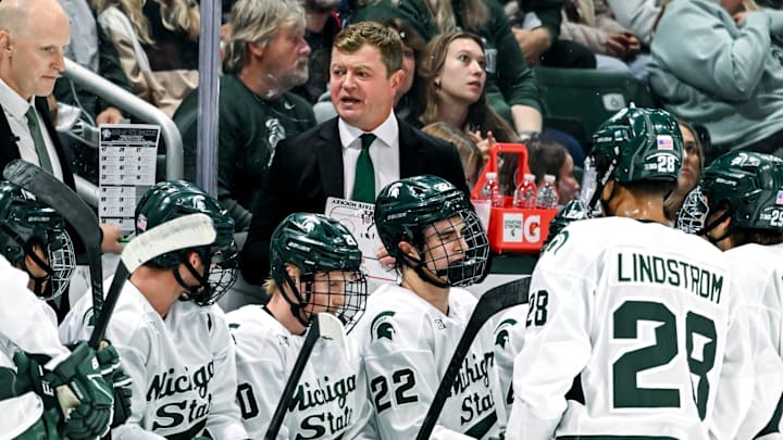 Michigan State's head coach Adam Nightingale, center, talks with the team during a break in the action in the first period of the game against New Hampshire on Thursday, Oct. 9, 2025, at Munn Ice Arena in East Lansing.