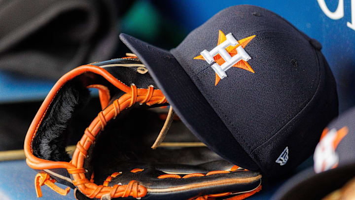 Apr 27, 2025; Kansas City, Missouri, USA; Houston Astros hat and glove in the dugout during the second inning against the Kansas City Royals at Kauffman Stadium. 