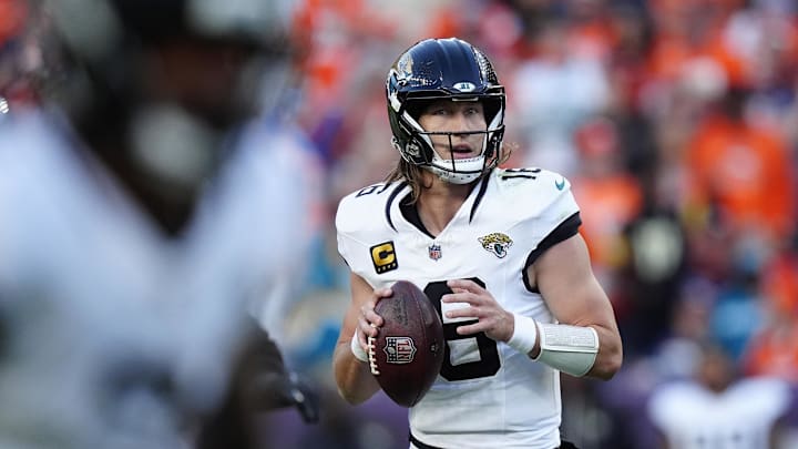 Dec 21, 2025; Denver, Colorado, USA; Jacksonville Jaguars quarterback Trevor Lawrence (16) drops back to pass against the Denver Broncos during the first half at Empower Field at Mile High. Mandatory Credit: Ron Chenoy-Imagn Images