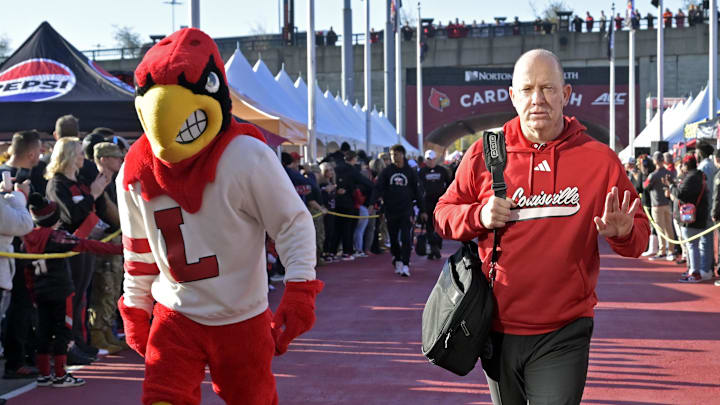 Oct 19, 2024; Louisville, Kentucky, USA; Louisville Cardinals head coach Jeff Brohm greets fans during the Card March before facing off against the Miami Hurricanes at L&N Federal Credit Union Stadium. 