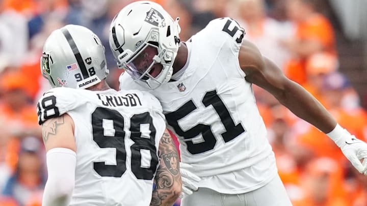 Sep 10, 2023; Denver, Colorado, USA; Las Vegas Raiders defensive end Malcolm Koonce (51) celebrates a sack with defensive end Maxx Crosby (98) against the Denver Broncos in the second quarter at Empower Field at Mile High. Mandatory Credit: Ron Chenoy-Imagn Images