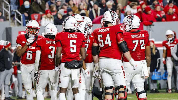 Nov 29, 2025; Raleigh, North Carolina, USA;  NC State Wolfpack huddles during the first half of the game against North Carolina Tar Heels at Carter-Finley Stadium.  Mandatory Credit: Jaylynn Nash-Imagn Images