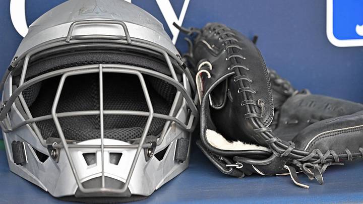 May 5, 2026; Kansas City, Missouri, USA; A catchers mask and glove are seen in the dugout before a game between the Cleveland Guardians and Kansas City Royals at Kauffman Stadium. Mandatory Credit: Peter Aiken-Imagn Images