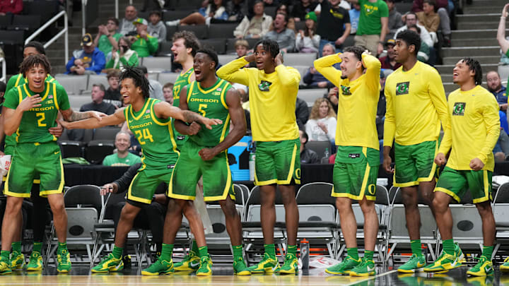 Dec 21, 2024; San Jose, California, USA; Oregon Ducks players react after a dunk by forward Supreme Cook (not shown) against the Stanford Cardinal during the second half at SAP Center at San Jose. Mandatory Credit: Darren Yamashita-Imagn Images