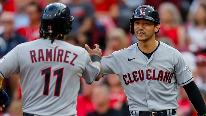 Aug 15, 2023; Cincinnati, Ohio, USA; Cleveland Guardians left fielder Steven Kwan (38) high fives third baseman Jose Ramirez (11) after scoring on a two-run single hit by first baseman Kole Calhoun (not pictured) in the first inning against the Cincinnati Reds at Great American Ball Park. Mandatory Credit: Katie Stratman-Imagn Images