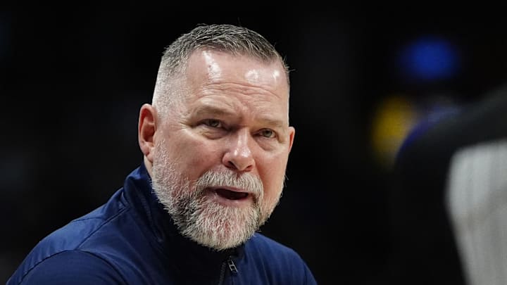 Apr 6, 2025; Denver, Colorado, USA; Denver Nuggets head coach Michael Malone reacts towards referee Danielle Scott (87) in the second half against the Indiana Pacers at Ball Arena. Mandatory Credit: Ron Chenoy-Imagn Images