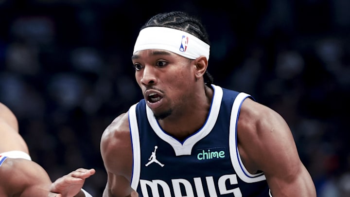 Mar 16, 2025; Dallas, Texas, USA;  Dallas Mavericks guard Brandon Williams (10) dribbles as Philadelphia 76ers guard Jared Butler (12) defends during the first half at American Airlines Center. Mandatory Credit: Kevin Jairaj-Imagn Images