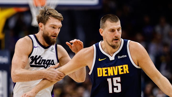 Denver Nuggets center Nikola Jokic (15) dribbles the ball up court as Sacramento Kings forward Domantas Sabonis (11) defends in the first quarter at Ball Arena.