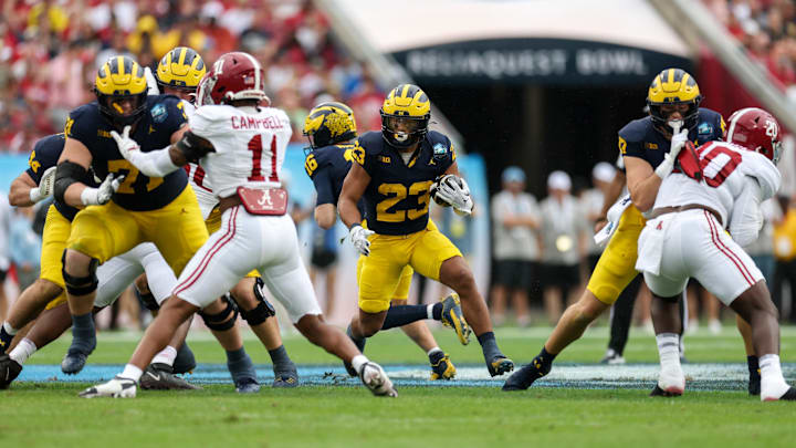 Michigan Wolverines running back Jordan Marshall (23) runs with the ball against the Alabama Crimson Tide in the first quarter during the ReliaQuest Bowl at Raymond James Stadium.