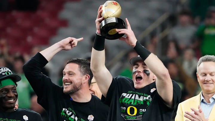 Oregon Ducks quarterback Bo Nix and head coach Dan Lanning celebrate after defeating the Liberty Flames to win the Fiesta Bowl at State Farm Stadium in Glendale on Jan. 1, 2024.
