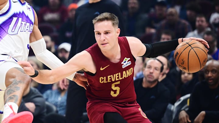 Jan 12, 2026; Cleveland, Ohio, USA; Cleveland Cavaliers guard Sam Merrill (5) drives to the basket against Utah Jazz guard Keyonte George (3) during the first quarter at Rocket Arena. Mandatory Credit: Ken Blaze-Imagn Images