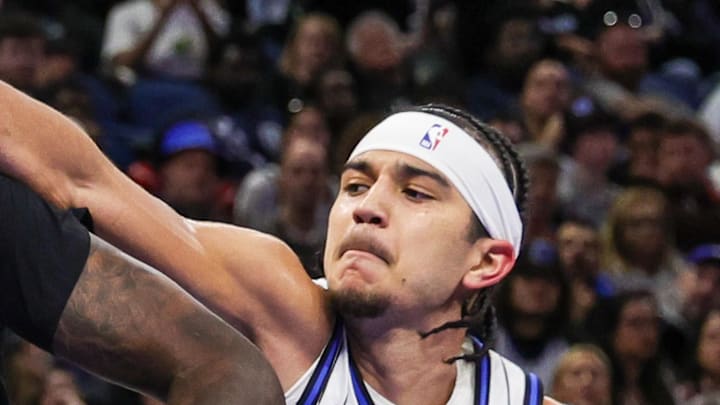Minnesota Timberwolves center Naz Reid is fouled by Orlando Magic guard Anthony Black.