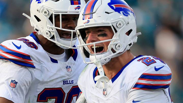 Buffalo Bills safety Sam Franklin Jr. (28), center, celebrates safety Cole Bishop (24), right, for grabbing a game-sealing interception, as defensive end Javon Solomon (56) looks on, in the final minute of the game during the fourth quarter of an NFL football AFC Wild Card playoff matchup, Sunday, Jan. 11, 2026, in Jacksonville, Fla. The Bills defeated the Jaguars 27-24. [Corey Perrine/Florida Times-Union]