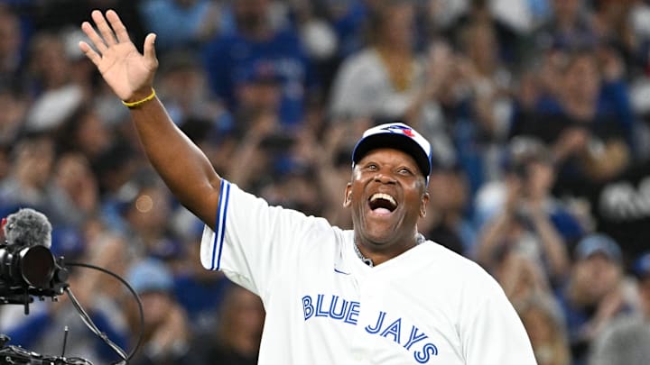 Toronto Blue Jays former player Joe Carter walks onto the field to throw out a ceremonial pitch.