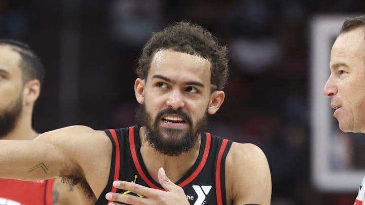 Mar 25, 2025; Houston, Texas, USA; Atlanta Hawks guard Trae Young (11) talks with an official while Houston Rockets forward Dillon Brooks (9) looks on during the second quarter at Toyota Center. Mandatory Credit: Troy Taormina-Imagn Images