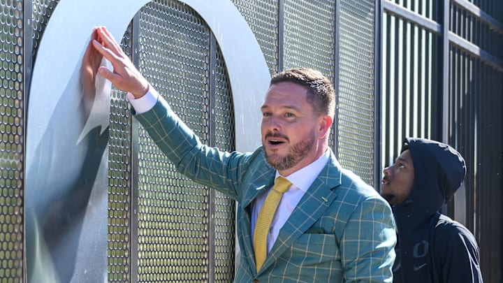 Oct 12, 2024; Eugene, Oregon, USA; Oregon Ducks head coach Dan Lanning touches the O during the walk-in before the game against the Ohio State Buckeyes at Autzen Stadium. Mandatory Credit: Craig Strobeck-Imagn Images