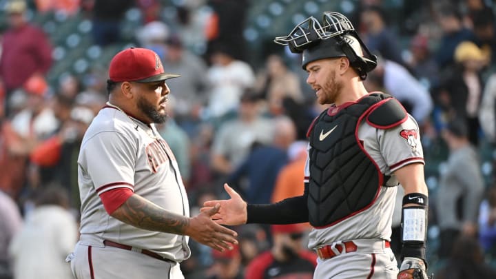 Oct 1, 2022; San Francisco, California, USA; Arizona Diamondbacks relief pitcher Reyes Moronta (59) shakes hands with catcher Cooper Hummel (21) after the final out of the game against the San Francisco Giants at Oracle Park. Mandatory Credit: Robert Edwards-USA TODAY Sports