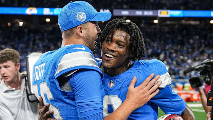 Detroit Lions quarterback Jared Goff (16) hugs wide receiver Jameson Williams (9)