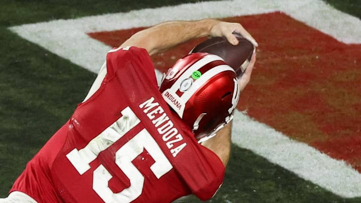 Jan 19, 2026; Miami Gardens, FL, USA; Indiana Hoosiers quarterback Fernando Mendoza (15) carries the ball for a touchdown against the Miami Hurricanes in the fourth quarter during the College Football Playoff National Championship game at Hard Rock Stadium. Mandatory Credit: Kim Klement Neitzel-Imagn Images