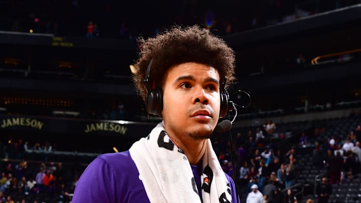 Former Phoenix Suns wing Cam Johnson wears a headset postgame.