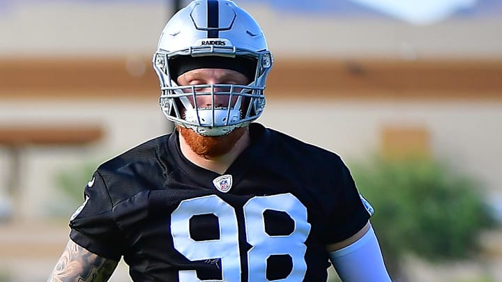 Jul 28, 2021; Las Vegas, NV, USA;  Las Vegas Raiders quarterback Derek Carr (4) and defensive end Maxx Crosby (98) are pictured during a team practice at Intermountain Healthcare Performance Center in Henderson. Mandatory Credit: Stephen R. Sylvanie-Imagn Images