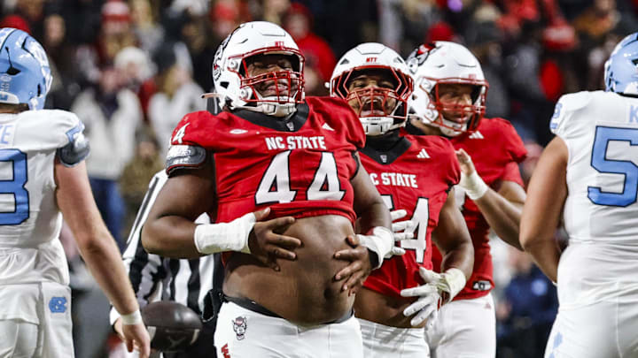 Nov 29, 2025; Raleigh, North Carolina, USA;  NC State Wolfpack defensive tackle Brandon Cleveland (44) reacts to his tackle during the first half of the game against North Carolina Tar Heels at Carter-Finley Stadium.  Mandatory Credit: Jaylynn Nash-Imagn Images