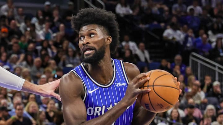 Orlando Magic forward Jonathan Isaac controls the ball against Denver Nuggets center Jonas Valanciunas.