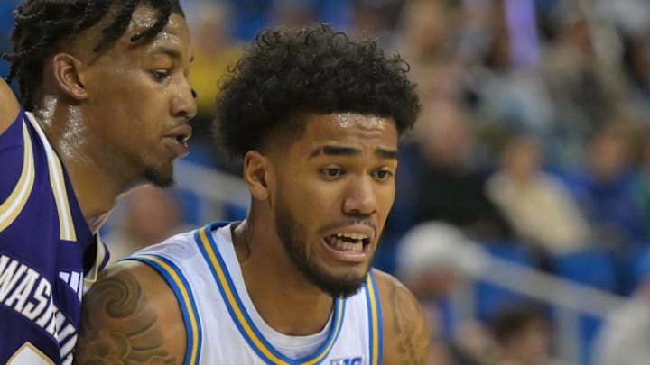 Feb 7, 2026; Los Angeles, California, USA;  UCLA Bruins guard Donovan Dent (2) is defended by Washington Huskies guard Wesley Yates III (9) as he drives to the basket in the first half at Pauley Pavilion presented by Wescom Financial. Mandatory Credit: Jayne Kamin-Oncea-Imagn Images