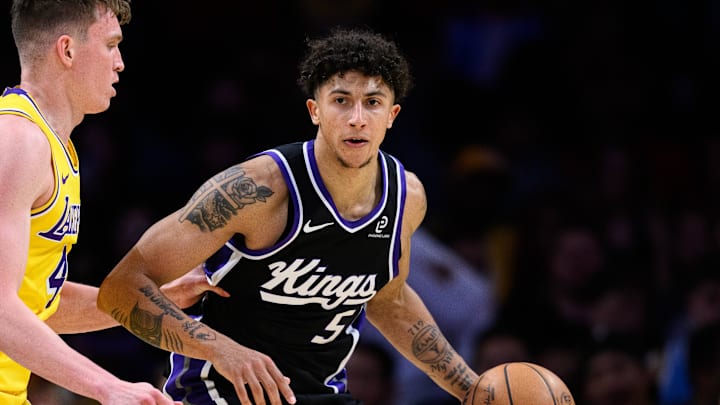 Oct 17, 2025; Los Angeles, California, USA; Sacramento Kings guard Nique Clifford (5) controls the ball while under pressure from Los Angeles Lakers forward Dalton Knecht (4) during the second half at Crypto.com Arena.