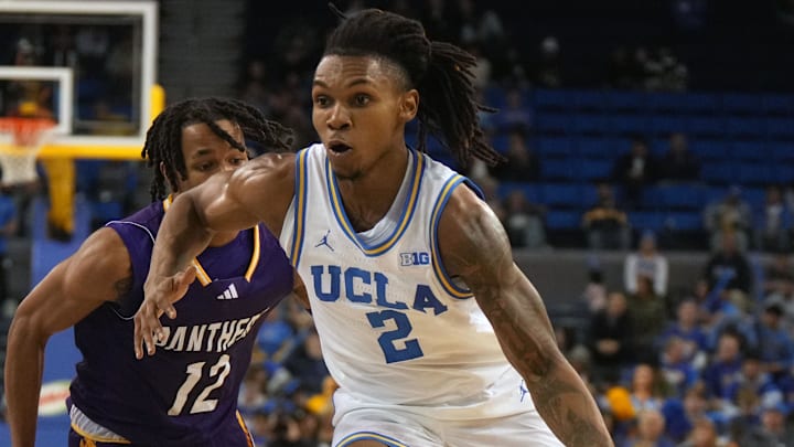 Dec 17, 2024; Los Angeles, California, USA; UCLA Bruins guard Dylan Andrews (2) dribbles the ball against Prairie View A&M Panthers guard Orlando Horton Jr. (12) in the second half at Pauley Pavilion presented by Wescom. Mandatory Credit: Kirby Lee-Imagn Images