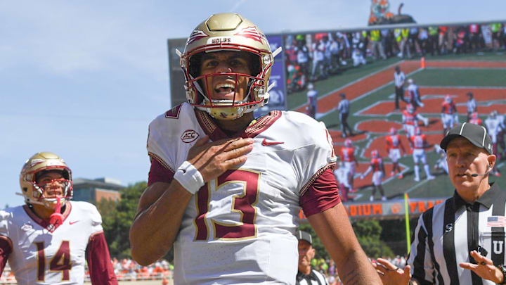 Sep 23, 2023; Clemson, South Carolina, USA; Florida State Seminoles quarterback Jordan Travis (13) reacts after scoring against the Clemson Tigers during the second quarter at Memorial Stadium. Mandatory Credit: Ken Ruinard-Imagn Images Sep 23, 2023; Clemson, South Carolina, USA; Florida State Seminoles quarterback Jordan Travis (13) reacts after scoring against the Clemson Tigers during the second quarter at Memorial Stadium. Mandatory Credit: Ken Ruinard-Imagn Images