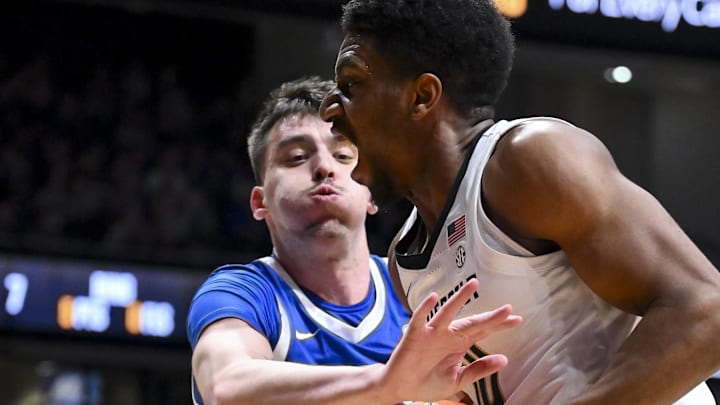 Jan 27, 2026; Nashville, Tennessee, USA;  Kentucky Wildcats forward Andrija Jelavic (4) pokes the ball fromVanderbilt Commodores forward Ak Okereke (10) during the second half at Memorial Gymnasium. Mandatory Credit: Steve Roberts-Imagn Images