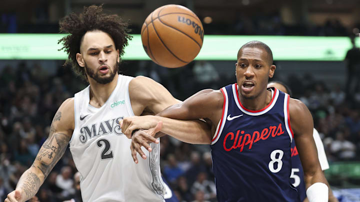 Dec 19, 2024; Dallas, Texas, USA;  LA Clippers guard Kris Dunn (8) and Dallas Mavericks center Dereck Lively II (2) go for the ball during the second half at American Airlines Center. Mandatory Credit: Kevin Jairaj-Imagn Images