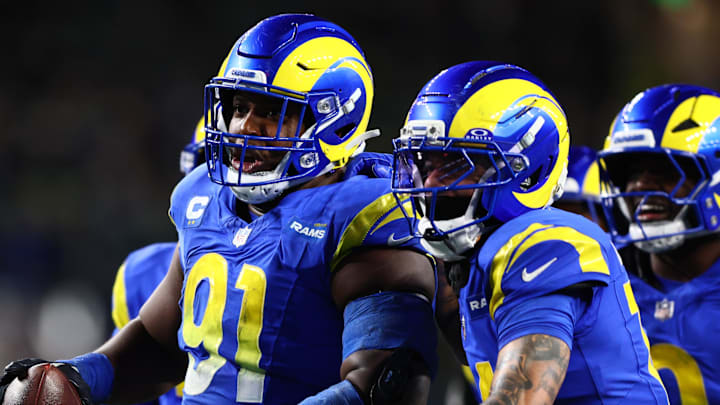 Dec 18, 2025; Seattle, Washington, USA; Los Angeles Rams defensive end Kobie Turner (91) celebrates after an interception against the Seattle Seahawks in the second half at Lumen Field. Mandatory Credit: Kevin Ng-Imagn Images